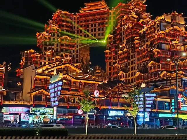 Illuminated 72 Wondrous Mansion building complex at night with lasers