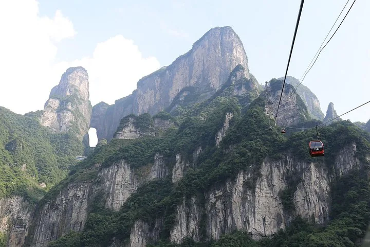 Cable cars moving towards the peaks of Tianmen Mountain