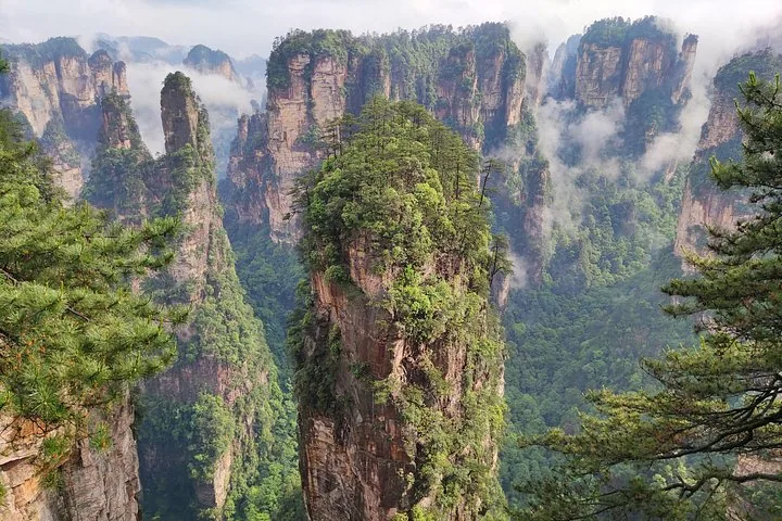 Towering sandstone pillars of Zhangjiajie National Forest Park with clouds